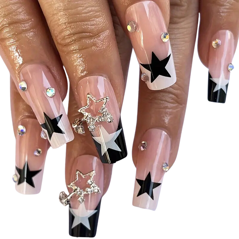 Nails with star designs and rhinestones. Bold French tip press-on nails with blue and white contrast