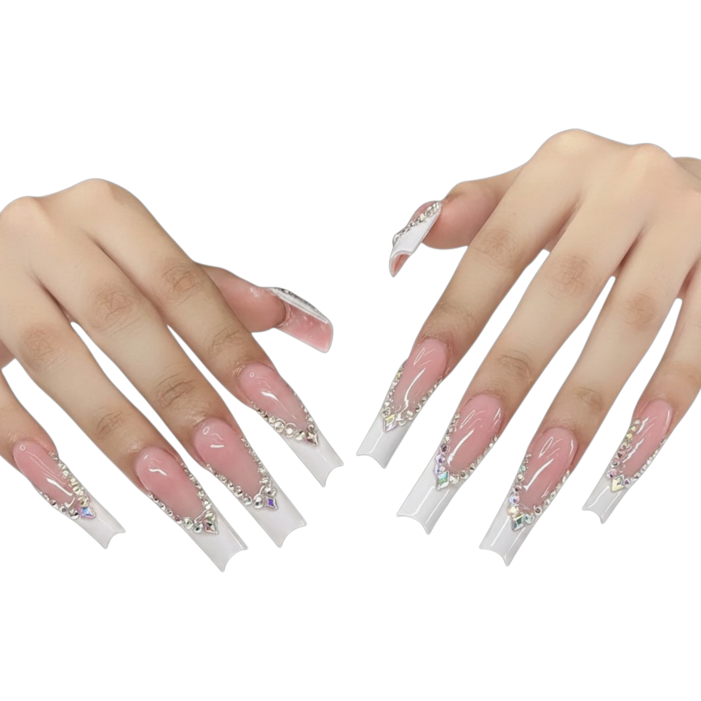 A pair of hands displaying long, coffin-shaped press-on nails with a glossy pink base, white tips, and silver rhinestone embellishments, set against a plain white background.