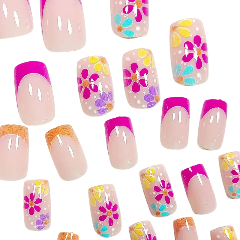 The Flowery Day Nails by Snazzi Nails features short square designs with vibrant pink tips, orange hues, and colorful flower patterns in pink, yellow, and purple on a light background—ideal for your next DIY full cover nail project.