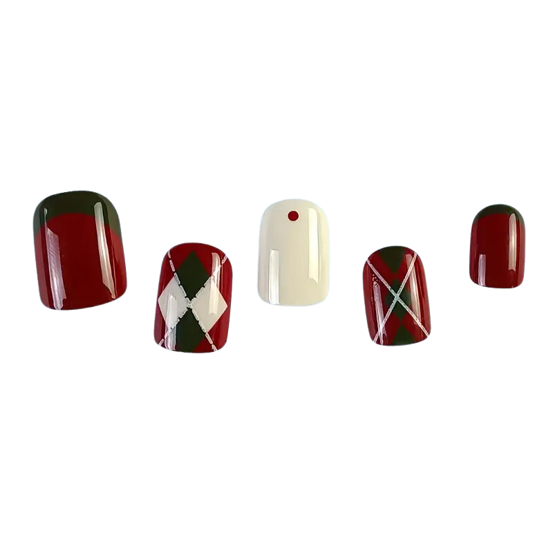 Five Rhomba Nails by Snazzi Nails, featuring a white background, display red, dark green, and white colors. They include salon-quality argyle patterns on three nails and one with a single red dot in the center.