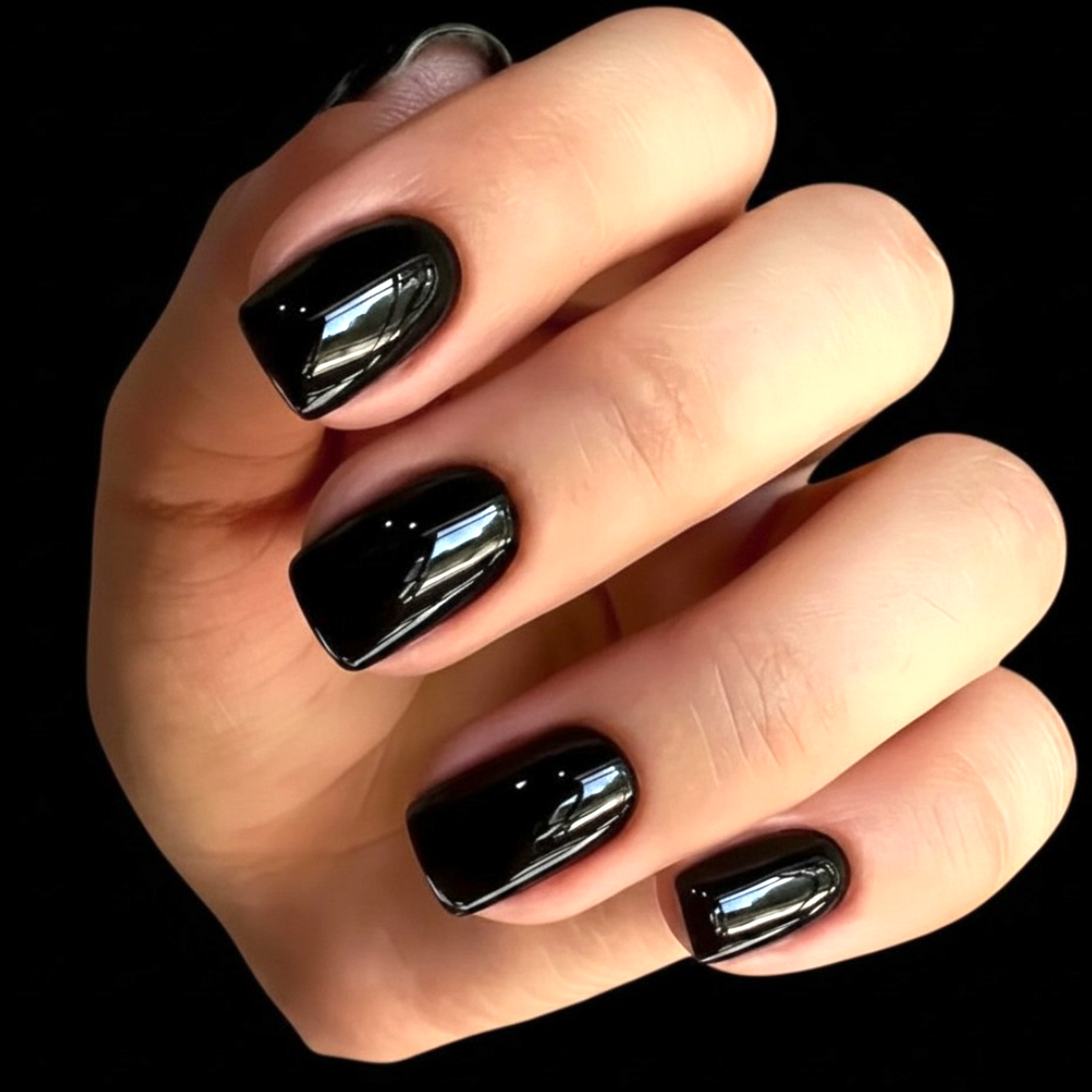 Snazzi Pink Shop Midnight Mood short square press-on nails in a glossy jet-black finish on a hand.