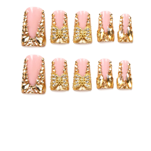 Snazzi Pink Shop Butterfly Glam long duckbill press-on nails with pink glossy finish, gold butterflies, and crystals.