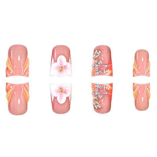 Snazzi Pink Shop Coral Starlet medium duckbill press-on nails with 3D flowers, silver star charms, and coral accents.
