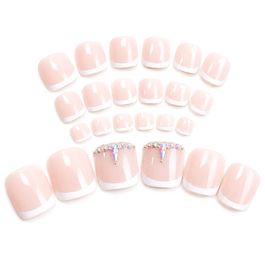 Snazzi Pink Shop Crystal French press-on toenails with white tips, natural base, and silver crystal accents.
