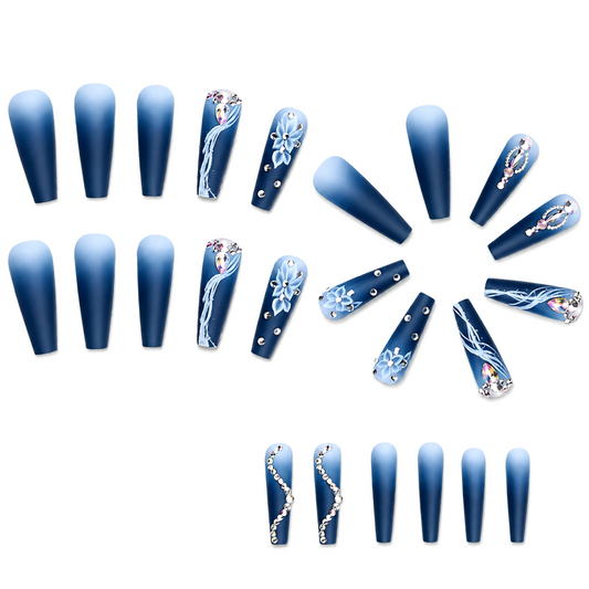 Snazzi Pink Shop extra long coffin press-on nails in navy blue ombré with floral accents and luxury rhinestones.
