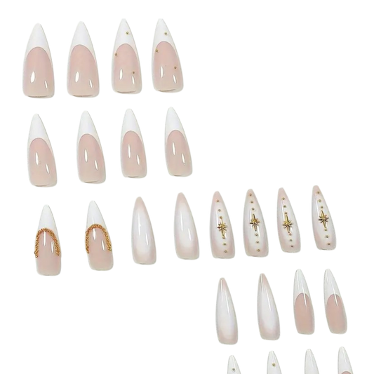 A set of long almond-shaped press-on nails arranged on a plain white background. The nails feature a glossy nude-pink base with white tips and small gold decorative accents, including stars, dots, and curved metallic trim.