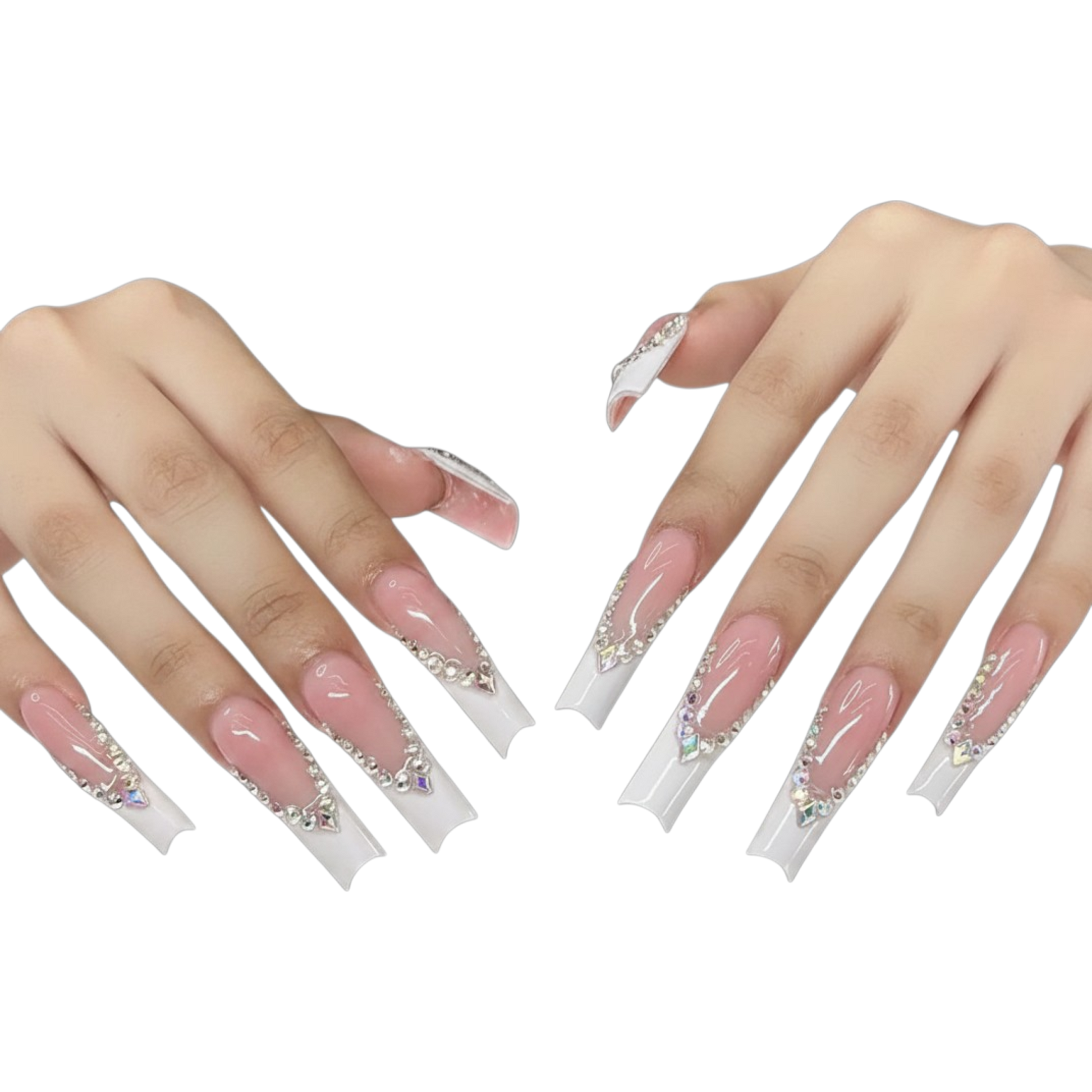 A pair of hands displaying long, coffin-shaped press-on nails with a glossy pink base, white tips, and silver rhinestone embellishments, set against a plain white background.