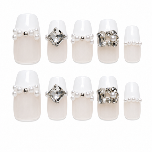 Pearl Poise medium coffin handmade nails with nude bases, white French tips, pearls and clear crystal accents