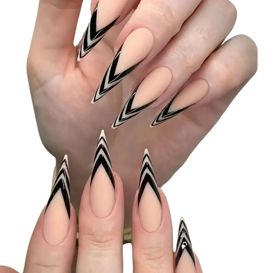 A hand showcasing extra long stiletto nails with a black French tip design, featuring bold split lines.