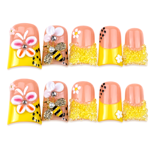 Snazzi Pink Shop Bee Dazzled short duckbill press-on nails with yellow beads, jeweled bee charms, and floral art.