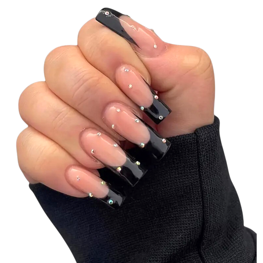 Snazzi Pink Shop extra long coffin press-on nails with black French tips, blush nude base, and crystal accents.