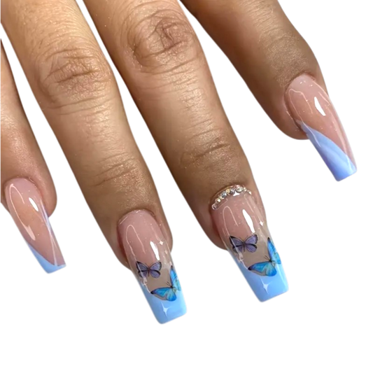 Snazzi Pink Shop long coffin press-on nails with baby blue French tips, butterfly art, and rhinestone accents.
