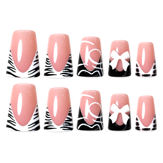 Snazzi Pink Shop Bow Instinct medium duckbill press-on nails with nude-pink base, zebra print, and white bow accents.