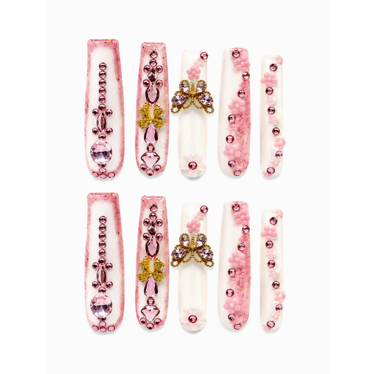 Snazzi Pink Shop 4XL square press-on nails in milky white and pink with gold butterfly charms, crystals, and flowers.