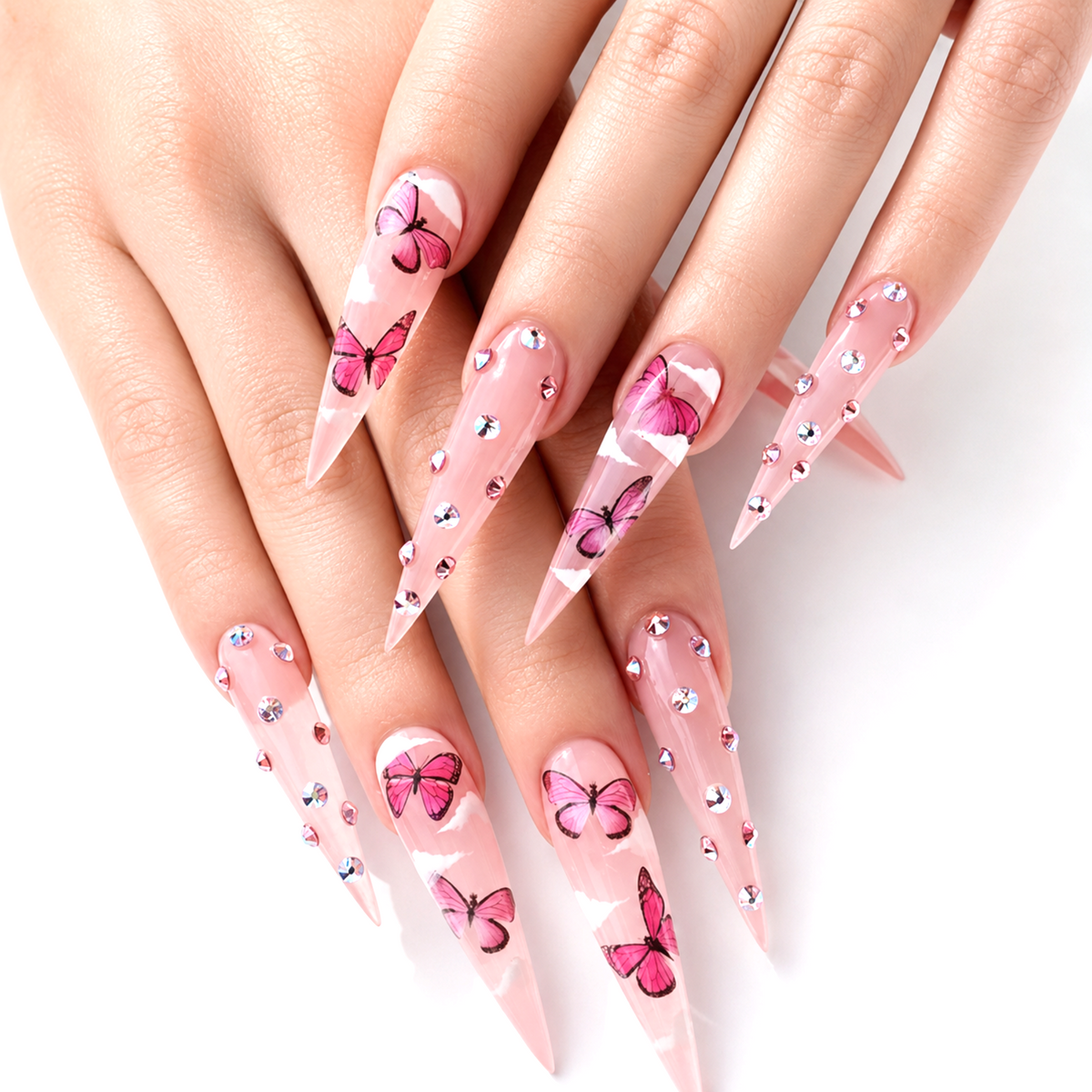 Snazzi Pink Shop extra long stiletto press-on nails with sheer pink base, butterfly art, and iridescent rhinestones.