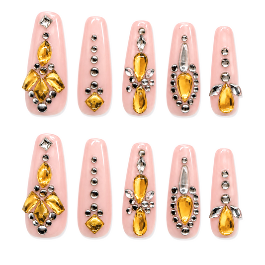 Snazzi Pink Shop Champagne Jewel extra long coffin press-on nails with glossy pink base, gold gems, and crystals.