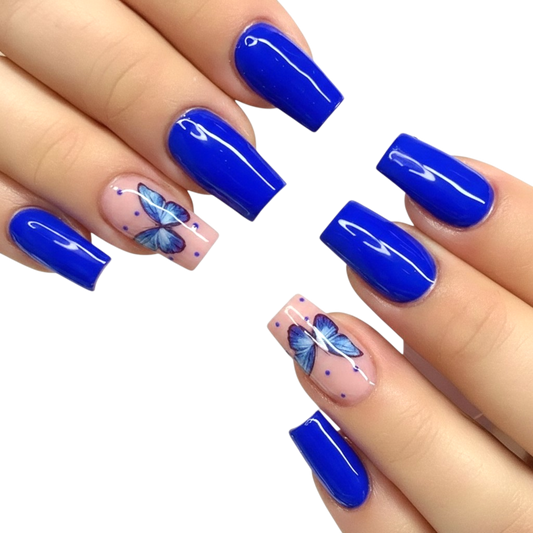 Snazzi Pink Shop long coffin press-on nails in royal blue with butterfly accent art and a glossy finish.