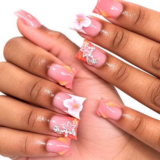 Snazzi Pink Shop Coral Starlet medium duckbill press-on nails with 3D pink flowers, silver stars, and coral waves.