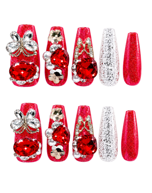 Snazzi Pink Shop Crimson Wings long coffin nails with red glitter, oversized gems, butterfly charms, and pearls.