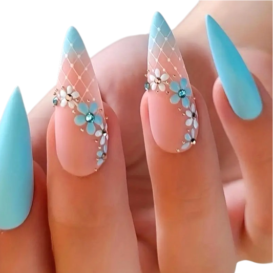 Snazzi Pink Shop Floral Sky long stiletto press-on nails with blue ombré, white lattice, and dimensional floral charms.