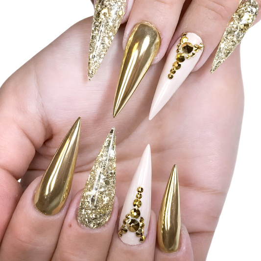 Snazzi Pink Shop Golden Hour extra long stiletto press-on nails with gold chrome, champagne glitter, and crystals.