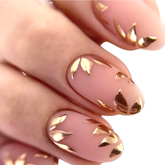 Snazzi Pink Shop Golden Leaves medium oval press-on nails with a matte nude base and metallic gold botanical accents.