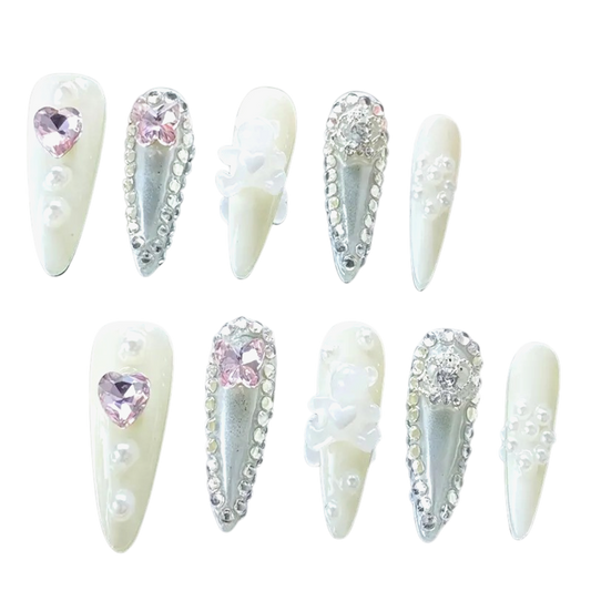 Snazzi Pink Shop Heavenly Vow extra-long stiletto nails with ivory, silver, pearls, pink hearts, and floral accents.