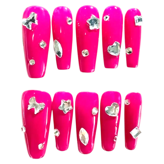 Snazzi Pink Shop extra-long coffin press-on nails in hot pink with silver heart, star, and butterfly crystal charms.