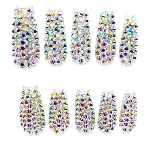 Snazzi Pink Shop Prism Reign extra long coffin nails fully encrusted with iridescent rhinestones for a bold look.