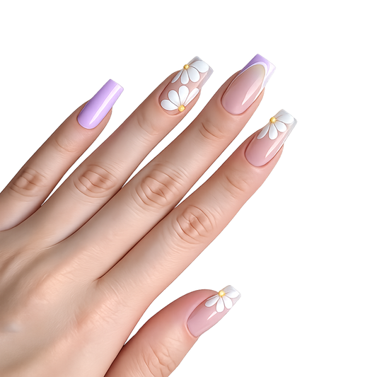 Snazzi Pink Shop long coffin press-on nails with nude-pink base, lilac French tips, and white daisy floral accents.