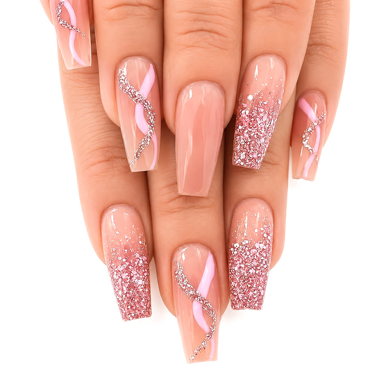 Snazzi Pink Shop long coffin press-on nails with sheer nude base, blush pink ribbons, and rose gold glitter accents.