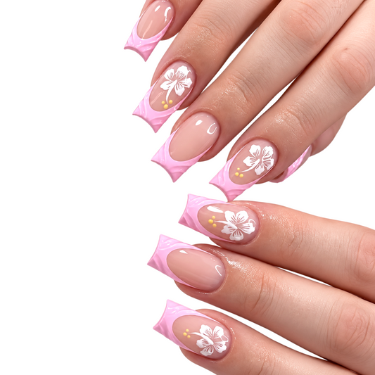 Snazzi Pink Shop long square press-on nails with nude-pink base, soft-pink French tips, white hibiscus art, and gold.
