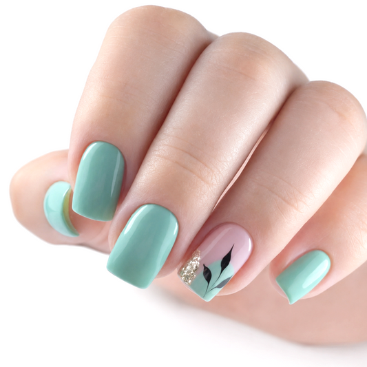 Snazzi Pink Shop Mint Leaf medium squoval press-on nails with mint green polish, botanical art, and gold glitter.