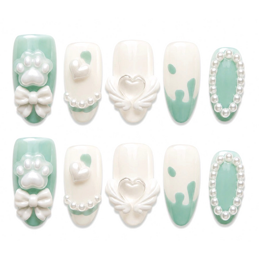 Snazzi Pink Shop Mint Paws medium almond press-on nails with mint green, white, pearl, bow, and heart accents.