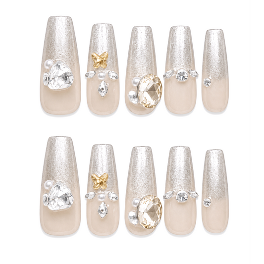 Snazzi Pink Shop Citrine Elegance extra long coffin nails with nude base, silver tips, butterflies, and crystals.