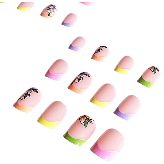Snazzi Pink Shop Petal Tip Parade short square press-on nails with pastel rainbow French tips and floral accents.