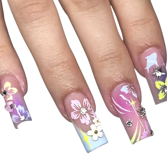 Snazzi Pink Shop long square press-on nails with pastel ombre, floral art, silver star charms, and rhinestones.