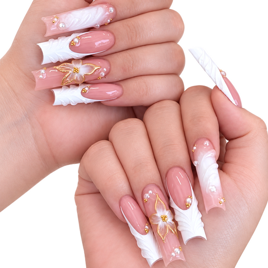 Snazzi Pink Shop Pearl Petals extra long square press-on nails with floral accents, pearl details, and gold trim.