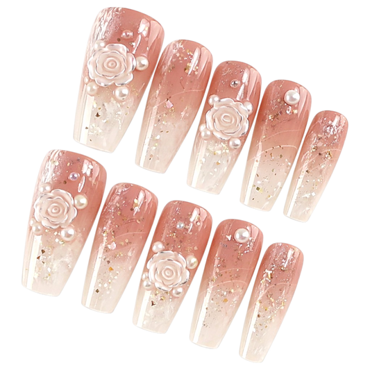 Snazzi Pink Shop Petal Poetry long coffin nails with pink gradient, ivory roses, pearls, and gold foil accents.