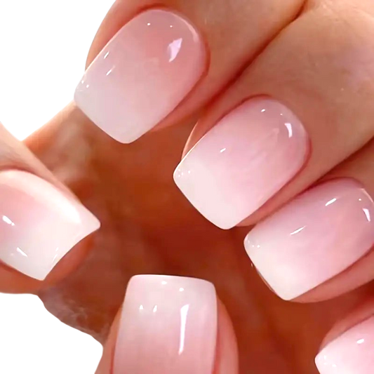 Snazzi Pink Shop Pink Whisper short square press-on nails with a glossy milky pink ombré finish.