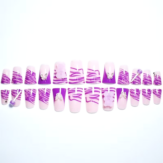 Snazzi Pink Shop Purple Candy Wings long duckbill press-on nails with zebra print, butterfly charms, and candy accents.