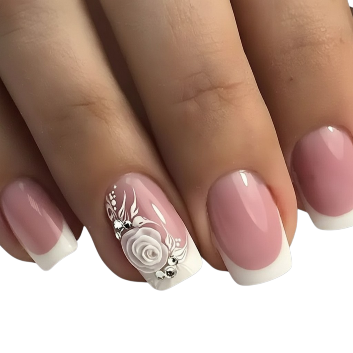 Snazzi Pink Shop medium squoval press-on nails with blush pink base, white French tips, 3D rose art, and crystals.