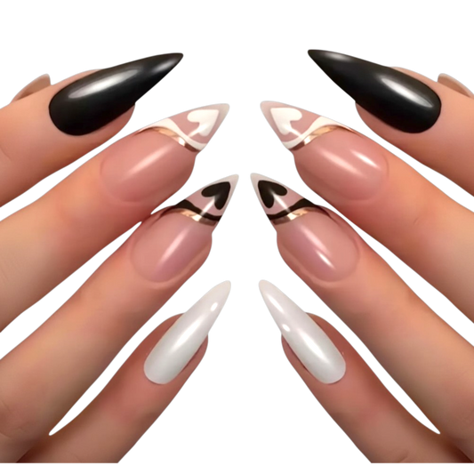 Snazzi Pink Shop extra long stiletto press-on nails with black, white, and gold heart French tip swirl designs.