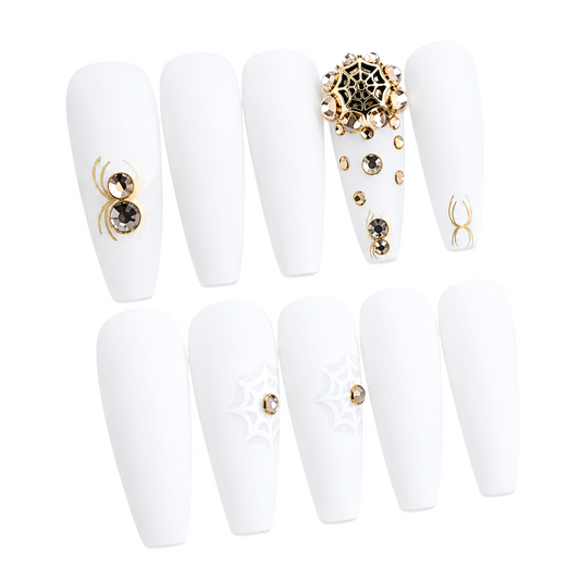 Snazzi Pink Shop extra long coffin press-on nails in matte white with gold spider web art and crystal embellishments.